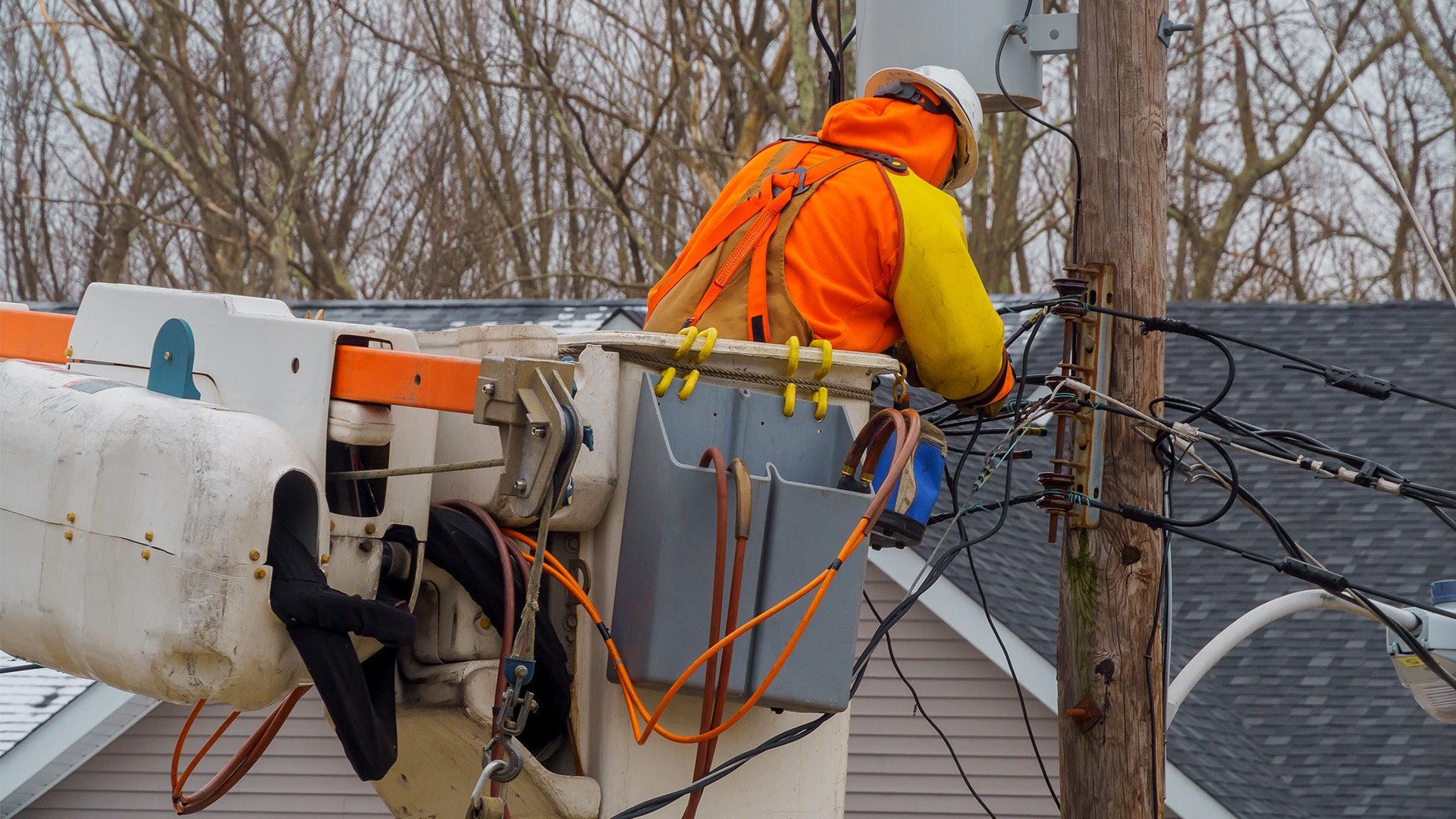 Utility worker fixing pole practicing OSHA safety